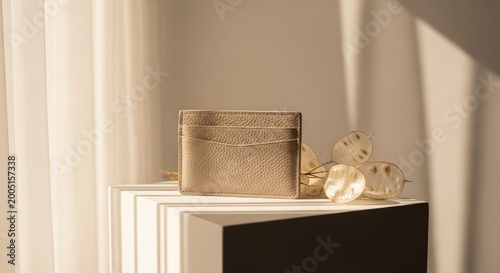 Elegant beige leather card holder in minimalist setting with natural light and stylish shadows
