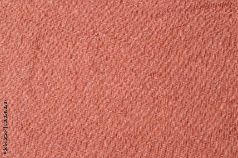 Fototapeta premium Texture of a fabric in warm tones with a soft and crinkled appearance on display in a neutral setting