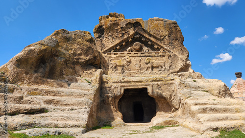 In Eskişehir, Turkey, the Solon’s Tomb (Lion Temple) in Phrygian Valley, showing its rock-cut façade with Roman-era lion reliefs beneath a triangular pediment featuring symbolic motifs