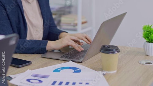  Close-up of businessman's hand typing out assessment of future business growth indicators, technology.