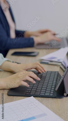 Close-up of businessman's hand typing out assessment of future business growth indicators, technology.