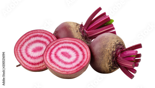 Bild auf Leinwand Sliced red beets with green leafy tops and whole root vegetable