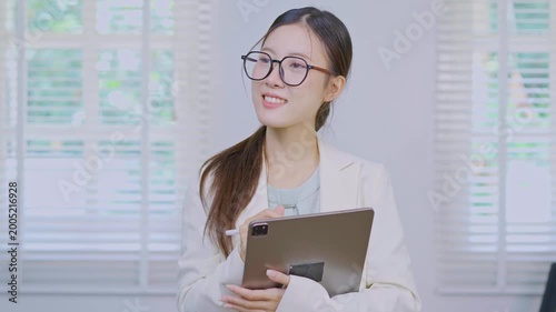  Close-up of successful businesswoman using digital tablet in front of modern business building.