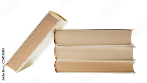Canvas Print Stacked beige hardcover books with one leaning at angle