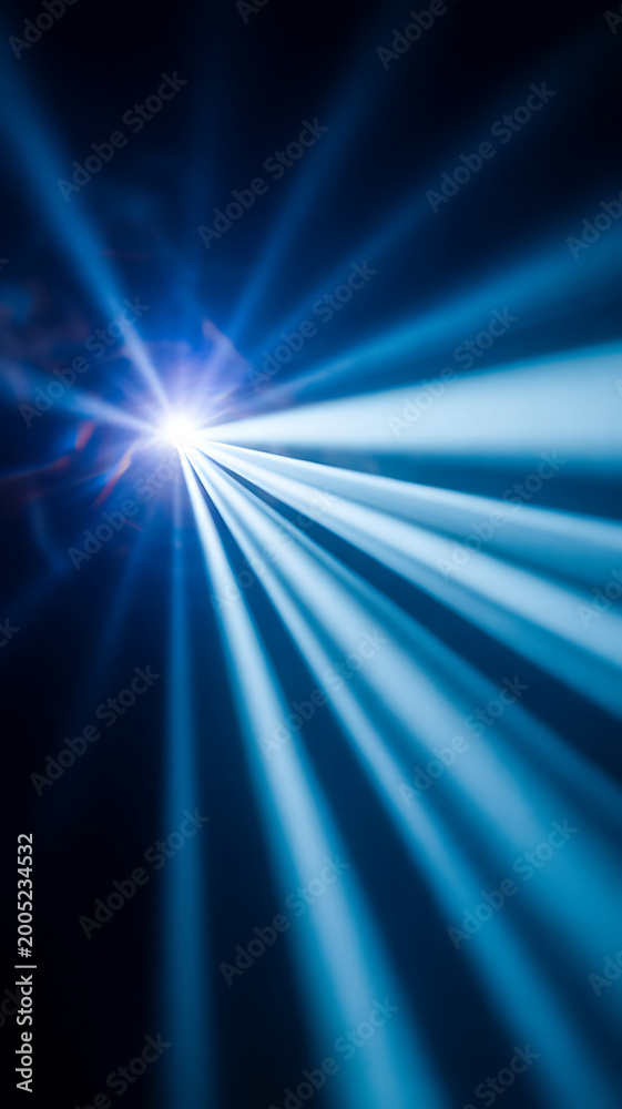 Fototapeta premium Bright blue light rays shining from a single point on a dark background with a beam of light