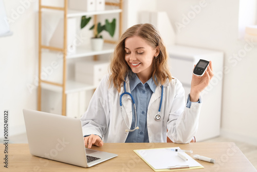Female doctor with glucomet...