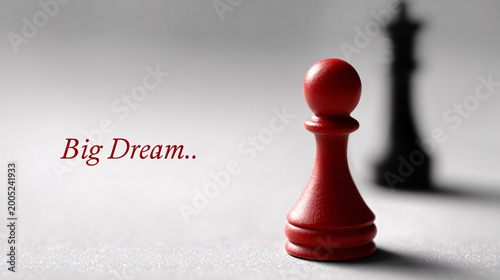 Red pawn chess piece standing before black king, symbolizing ambition and big dreams Conceptual business strategy, leadership, competition, and overcoming challenges to achieve success in professional