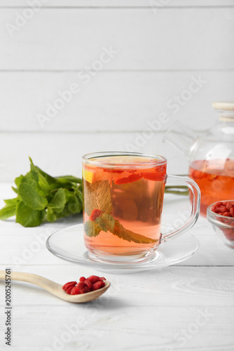 Glass cup of hot goji tea w...