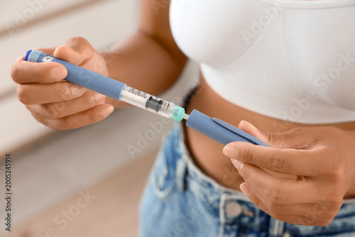 Woman with injection at hom...