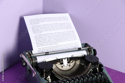 Vintage typewriter on purpl...
