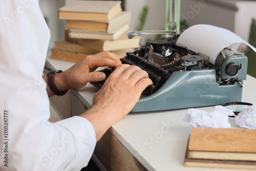 Young male writer with vint...