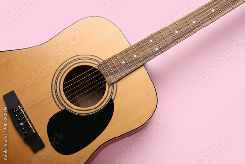 Acoustic guitar on pink bac...