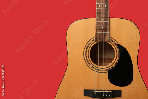 Modern guitar on red backgr...