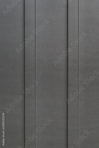 Dark gray metal panels with vertical lines