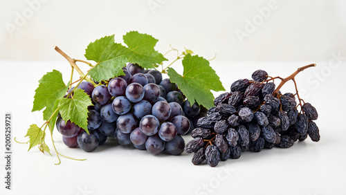 Fresh grapes are placed next to dried grapes on a natural background.