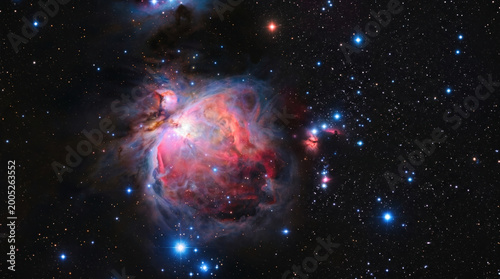 Stunning view of colorful Orion cosmic nebula with bright stars and dust clouds in deep space, showcasing vibrant hues and celestial beauty