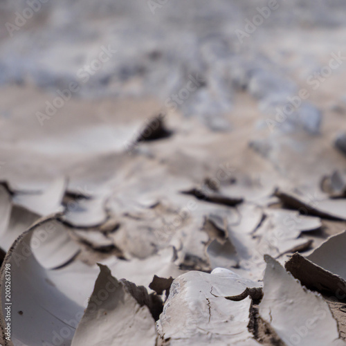Drying Cracked Clay Flakes Close Up Abstract Earth Texture