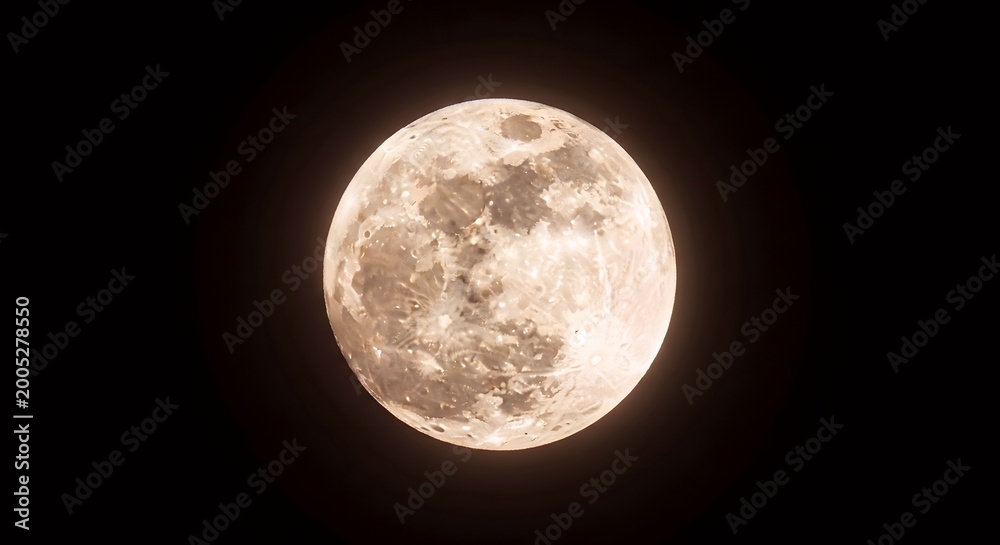 Fototapeta premium A close-up, detailed view of the full moon against a dark, starless night sky, showcasing its craters and surface texture.