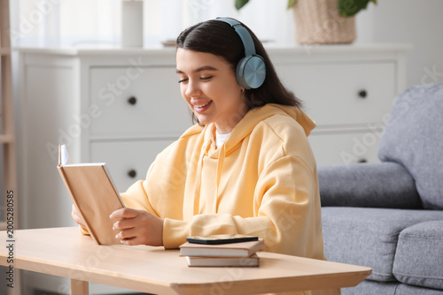 Happy young woman with book...