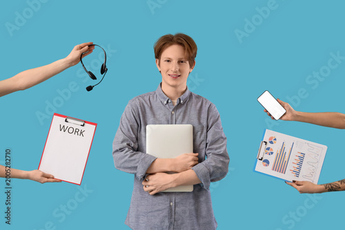 Teenage boy surrounded by hands with mobile phone, headset, charts and work a...