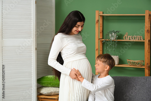 Boy and his pregnant mother...