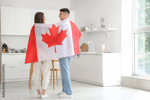 Young couple with flag of C...
