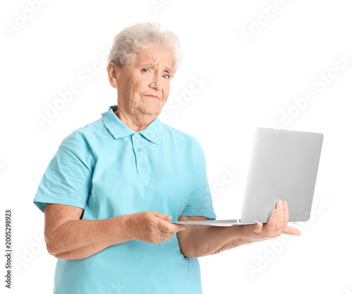 Senior woman using laptop o...