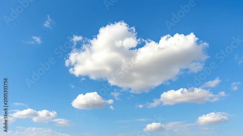 Celestial Canvas: Fluffy clouds drift gracefully across a vivid blue sky, creating a serene and captivating display of nature's artistry. 