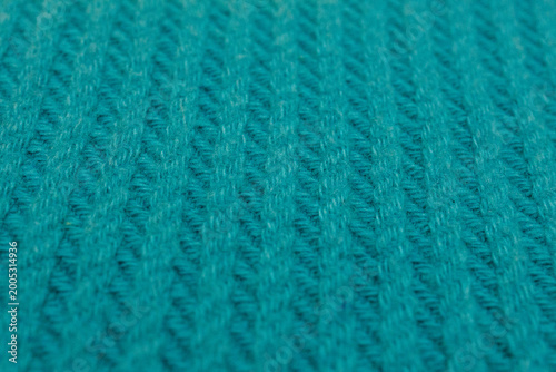 Close up of teal knitted fabric texture soft wool textile background for cozy design