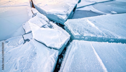 Close up of cracked ice with blue and white hues abstract natural pattern