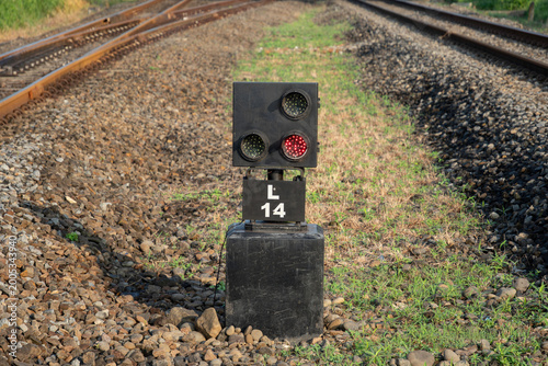 Bild auf Leinwand Ground railway signal with lights on a black base at a train track junction