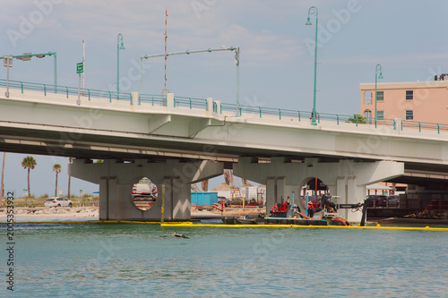 Slika na platnu Coastal Bridge Over Water With Construction Barge and Beach Renourishment Maintenance Underpass on Sunny Day