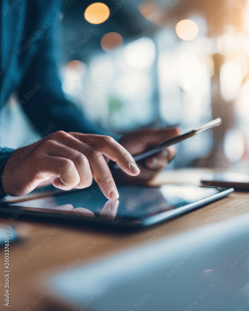 Fototapeta premium Close-up of hands using latest technology devices and modern digital tools in contemporary business workflow capturing modern workplace technology innovation and inspiring digital productivity concept