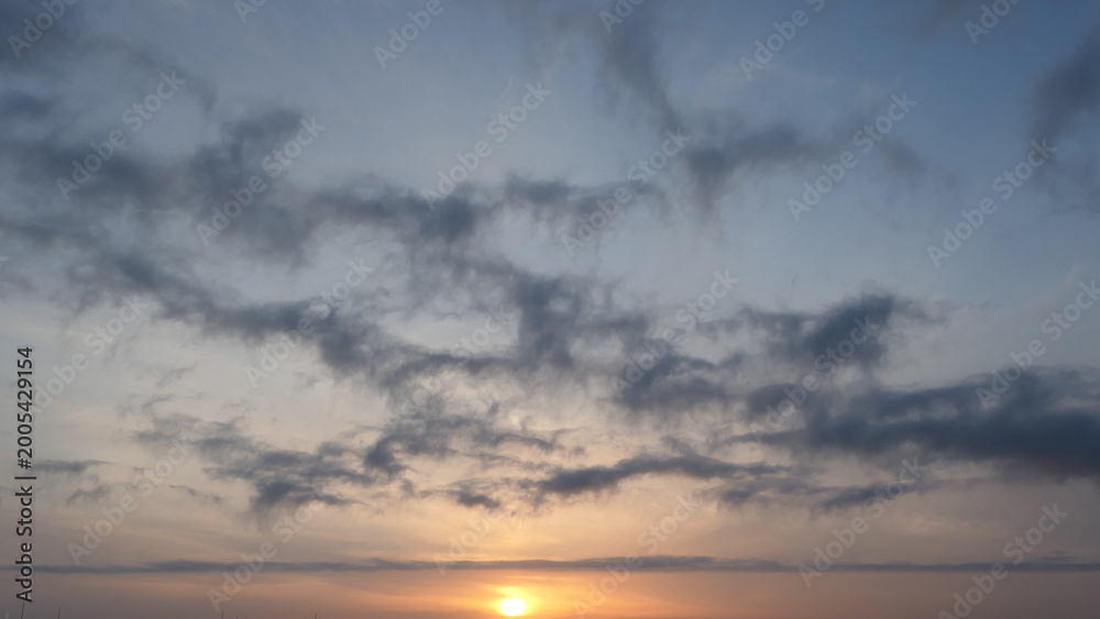 Fototapeta premium Dramatic Sunset Sky with Layered Clouds