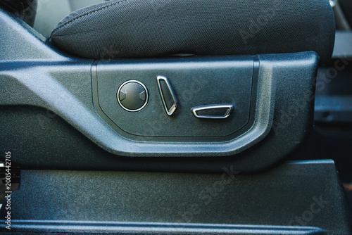 Obraz na płótnie Adjustable car seat controls are located on the side of the seat, allowing users