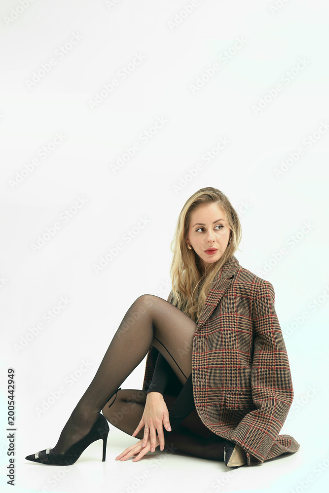 Fototapeta premium sexual girl female in stylish brown checkered jacket on shoulders outfit isolated on white background posing Lady wearing high heels pants black tights nylon pantyhose leotard Old money dress style