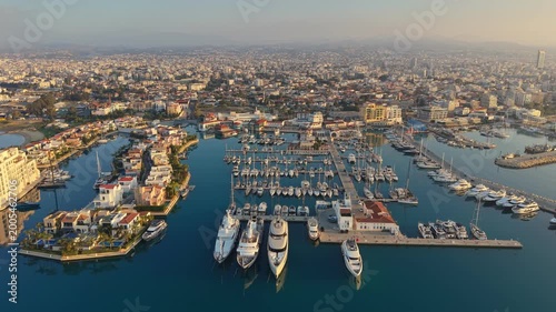 Impressive aerial view of luxury Limassol Marina featuring expensive yachts and private villas. Residential area of Limassol Marina with stunning swimming pools, elegant boats, Cyprus