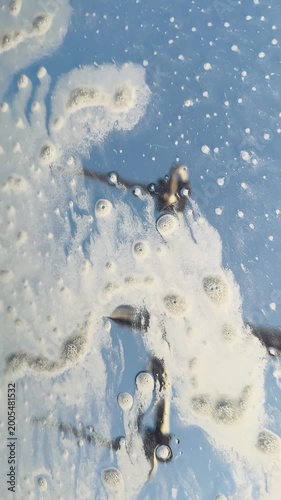 Car washing process with foam on a blue sky background  