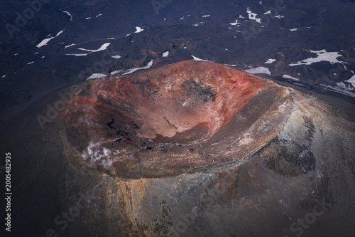 Aerial view of Okmok Volcano caldera with crater lake and glacial snow, Umnak Island, Alaska