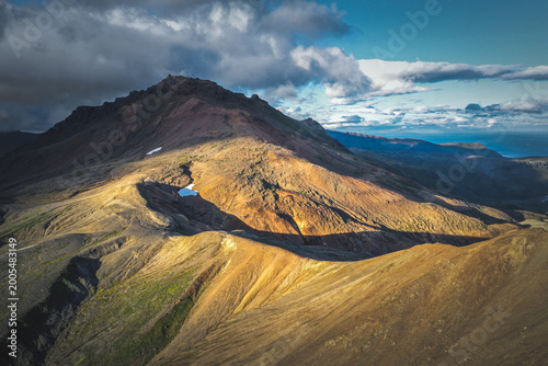 Canvastavla Aerial view of Okmok Volcano caldera with crater lake and glacial snow, Umnak Is