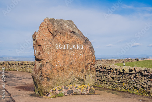 Obraz na plátne Boundary stone sign marking the Scotland border along A68 road in the Anglo-Scot