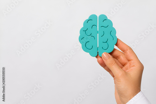 Human Hand Holding Brain Symbol on White Background – Mental Health Awareness, Therapy and Mind Care Concept