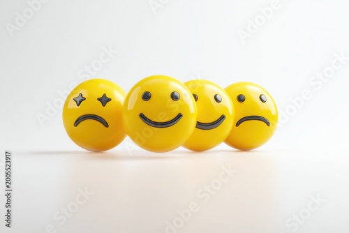 Four smiley face emojis showing different emotions on white background