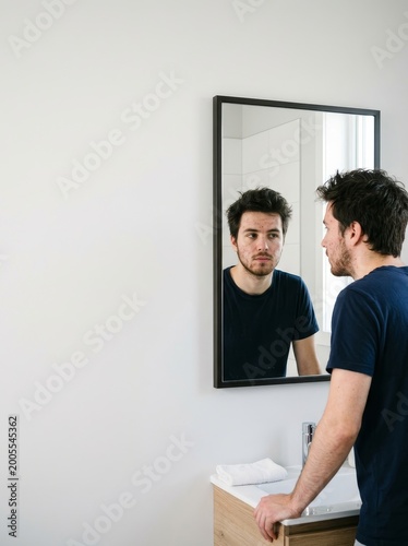 Self-reflection action home bathroom portrait image modern minimalist side view personal growth concept
