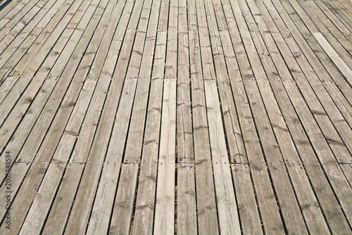Rustic outdoor timber decking with vertical parallel lines and textured surface detail ideal for architectural and lifestyle concepts.