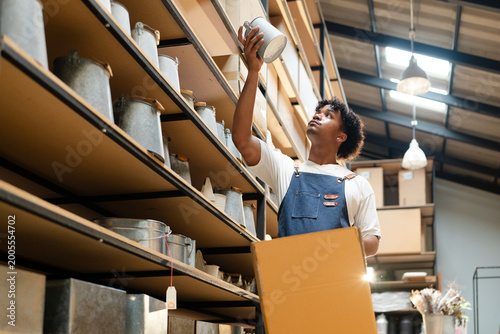 Photography warehouse worker arrange brown paper box container checking inventory in store r