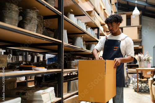 Canvas Print warehouse worker arrange brown paper box container checking inventory in store r