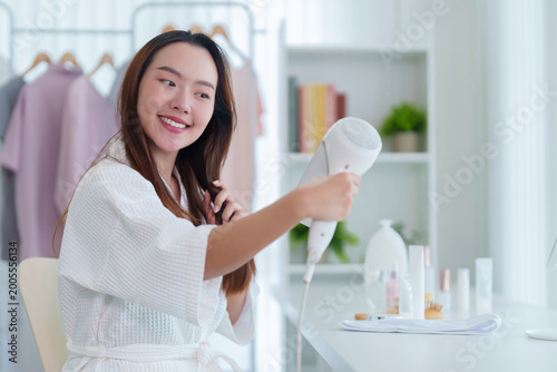 young Asian women enjoy morning routine using hand mirror makeup beauty care skincare product bathroom home lifestyle happy smile cheerful wellness selfcare