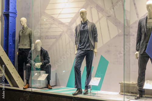 mannequins in a shop window wearing autumn clothes