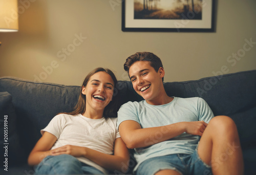 young friends laughing on couch, enjoying time together at home